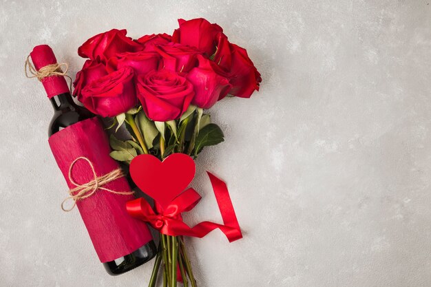 Wine bouquet of roses and heath sign on grey table