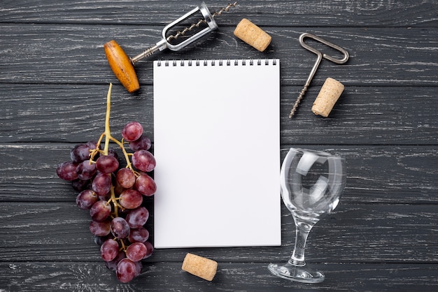 Free photo wine glass beside notebook on table