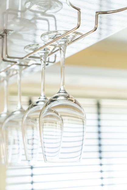 Wine's glass hanging on bar.