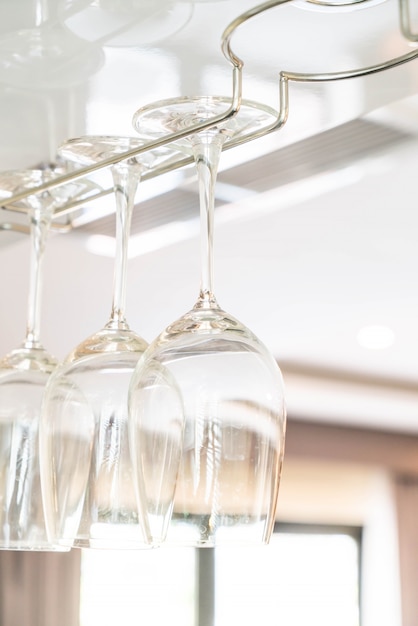 Wine's glass hanging on bar.