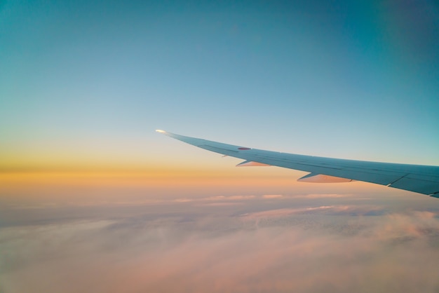 Free Photo wing of an airplane flying above the clouds