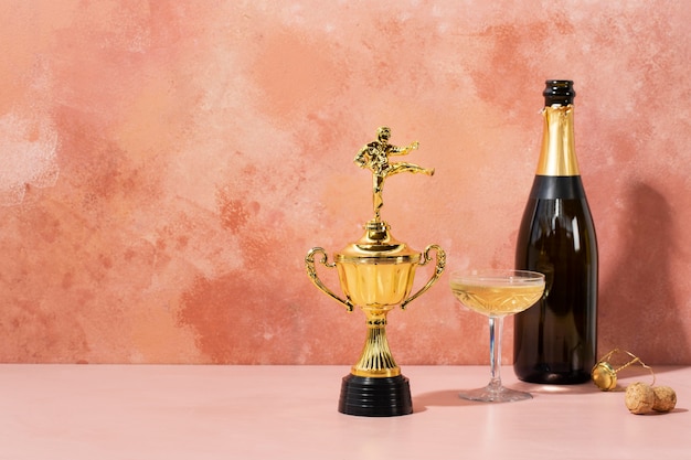 Free Photo winner concept with golden prize and drink