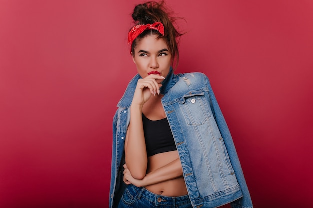 Free Photo winsome brunette girl in denim jacket playfully posing 