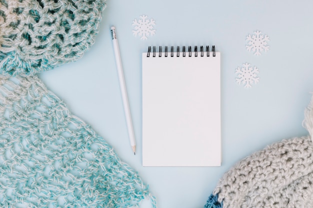 Winter composition of notepad with scarf 