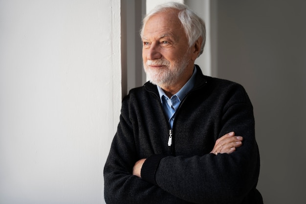 Wise man posing in studio medium shot