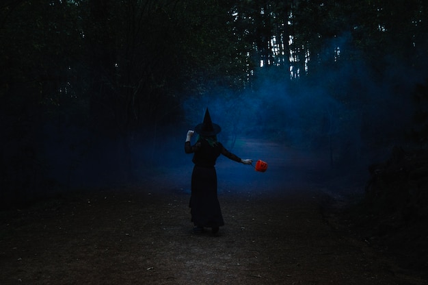 Free photo witch dancing in dark forest