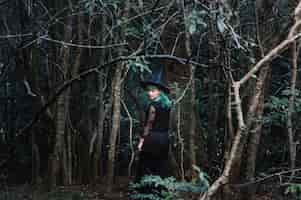 Free photo witch in dark wood