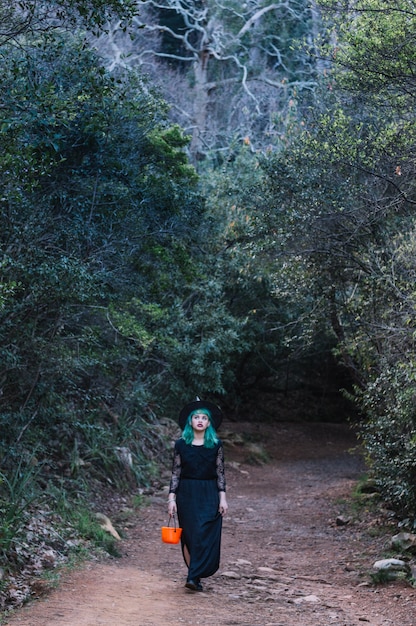 Free photo witch woman with pumpkin