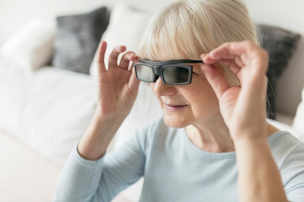 Free Photo woman adjusting 3d glasses while watching film