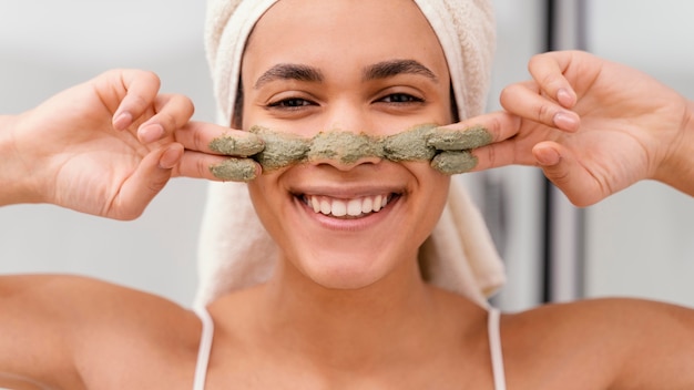 Free Photo woman applying a homemade treatment on her face