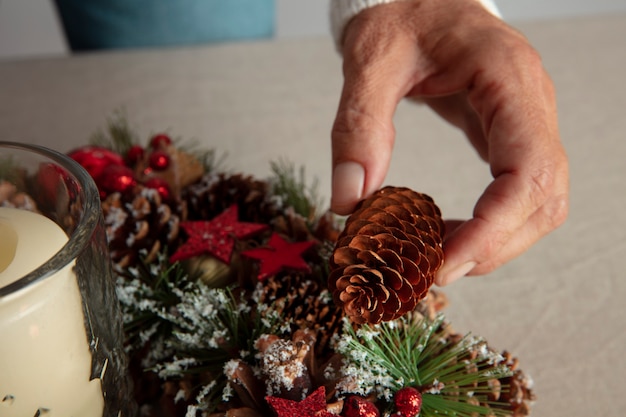 Free photo woman assembling holiday themed wreath