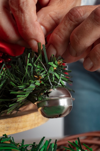 Free photo woman assembling holiday themed wreath