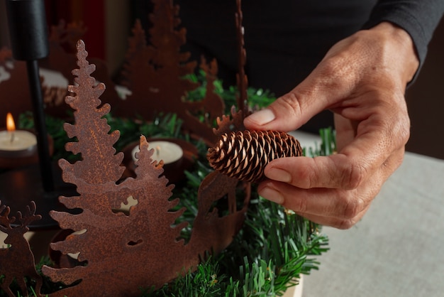 Free photo woman assembling holiday themed wreath