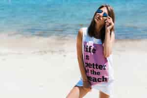 Free photo woman in baggy tank top adjusting sunglasses