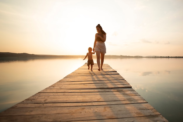 Woman at the beach with her baby enjoying the sunset