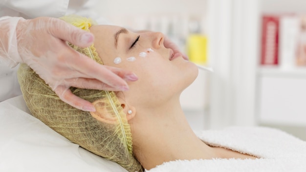 Woman at beauty clinic for face treatment