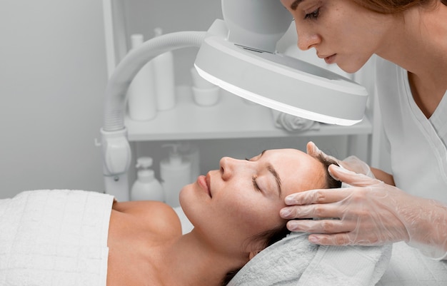 Woman at beauty salon for face treatment