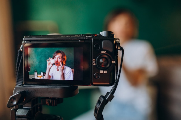 Woman beauty vlogger filming vlog about creams