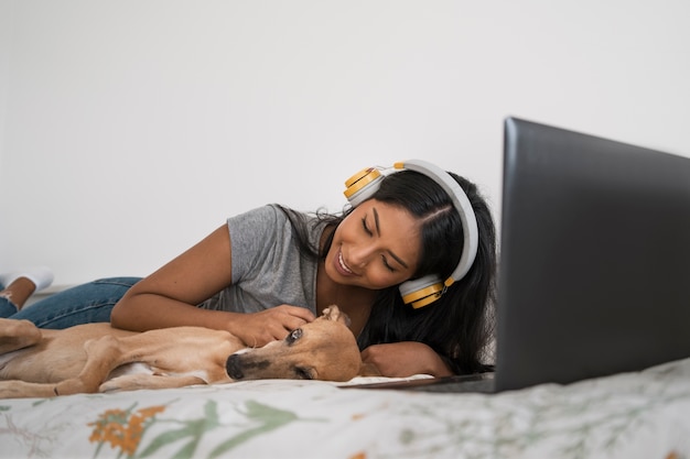 Woman in bed with dog front view