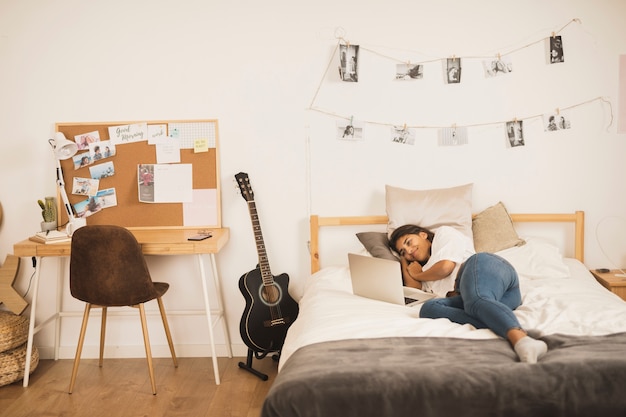 Woman in bed working on laptop