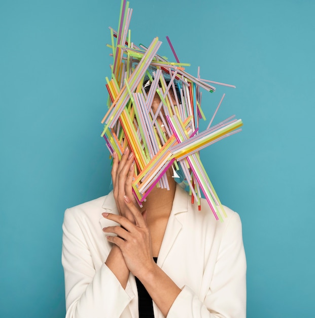 Free photo woman being covered in colorful plastic straws