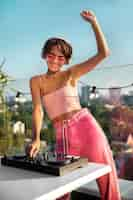 Free photo woman being dj at party medium shot