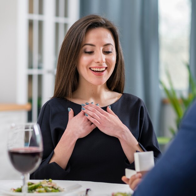 Woman being happy about being asked to marry her boyfriend