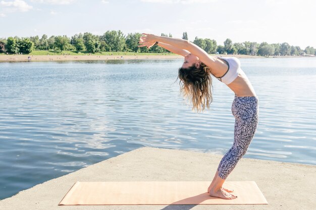 Woman bending back at water