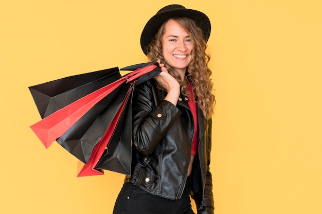 Woman on black friday sale holding many shopping bags