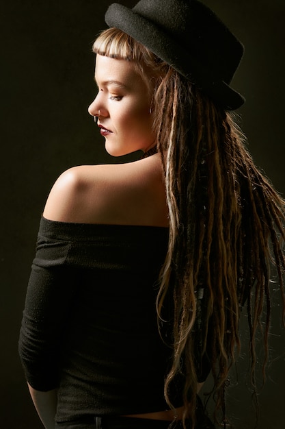 Woman in black hat and black off shoulder top 