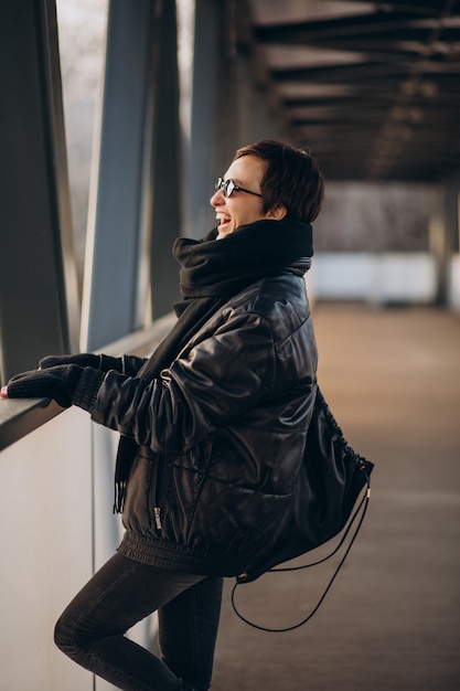 Woman in black jacket walking through the bridge