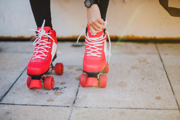 Woman in black leggings putting on rollerskates