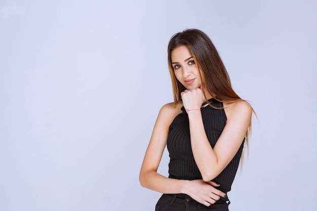 Woman in black shirt giving seductive and appealing poses. 