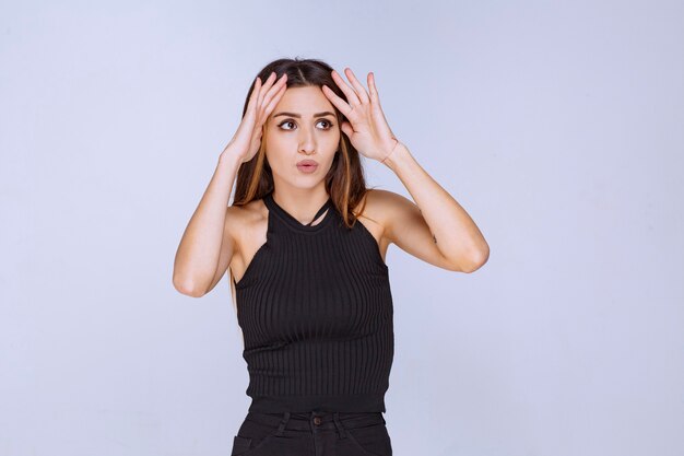 Woman in black shirt giving seductive and appealing poses. 