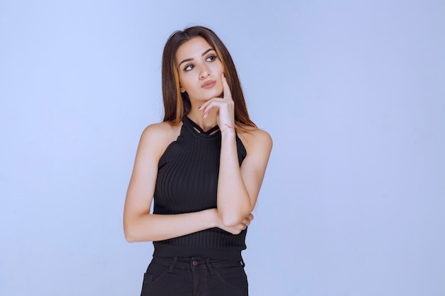 Woman in black shirt smiling. 