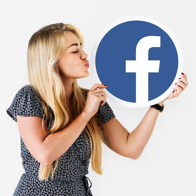 Free photo woman blowing a kiss to a facebook icon