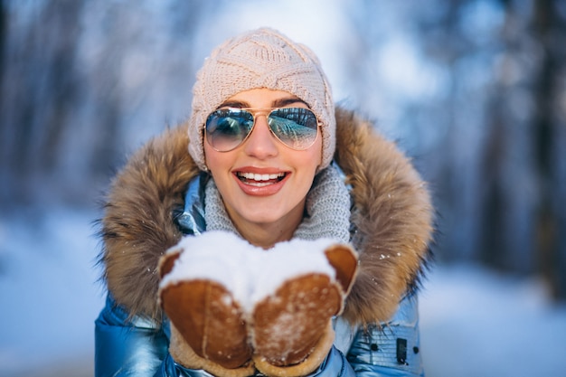 Woman blowing snow from gloves