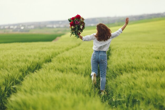 Woman in blue shirt  in a summer field