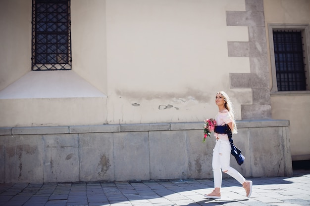 Free Photo woman in blue shirt walks along the street 