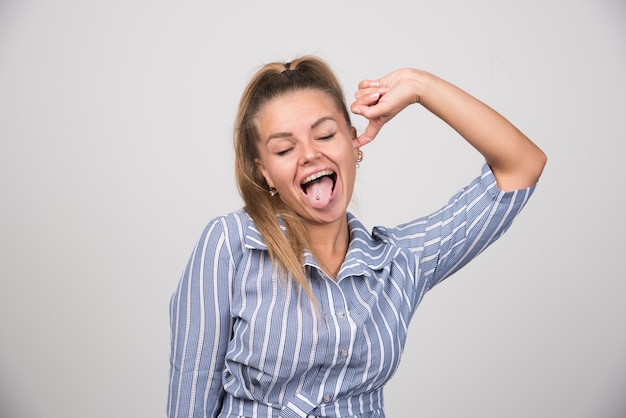 Woman in blue sweater getting tired of noise.