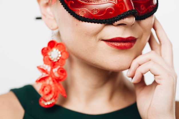 Free photo woman in bright red carnival mask