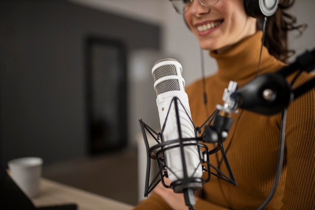 Free Photo woman broadcasting on radio while smiling