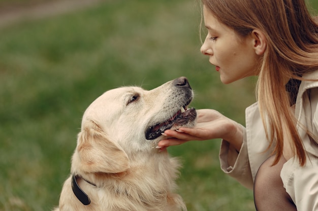 Free photo woman in a brown coat. lady with a labrador