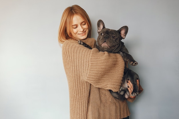 woman in a brown sweater with black bulldog