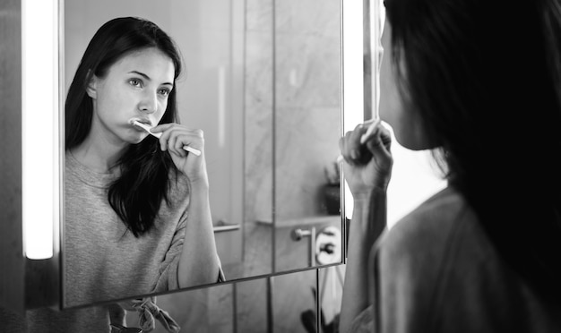 Woman brushing her teeth in the morning