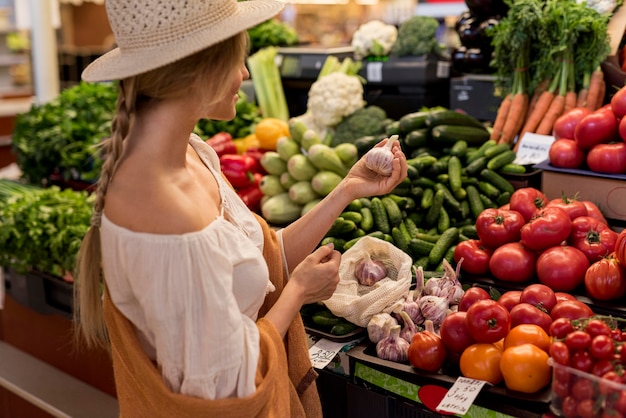 Woman buying garlic from market place