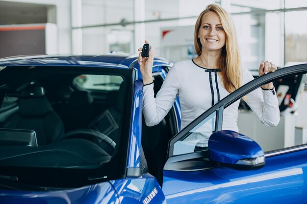 Woman buying a new car in a car salon