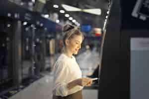 Free photo woman buys a ticket on the subway