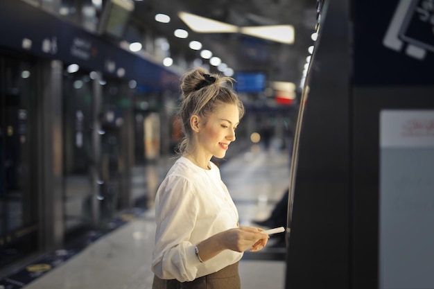 Free Photo woman buys a ticket on the subway