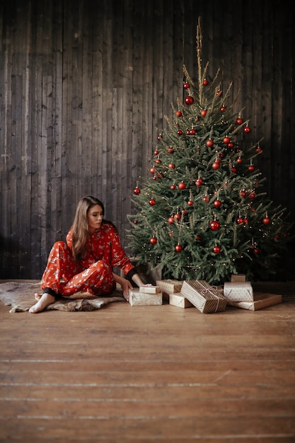 Woman by the Christmas tree